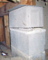 Concrete crawl space support posts in Watertown that are showing signs of failure as they sink into the earth.