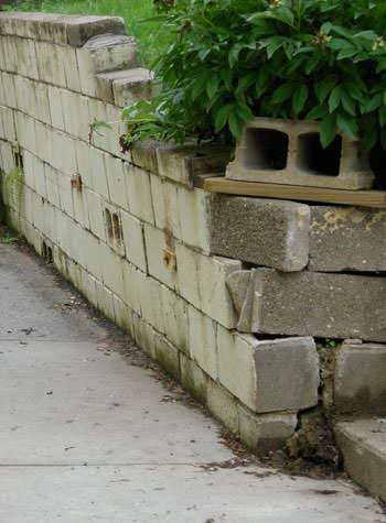 collapsing retaining wall with severe damage in Reedsburg