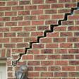 stair step cracking reaching from a window along the foundation wall in Rockford, IL
