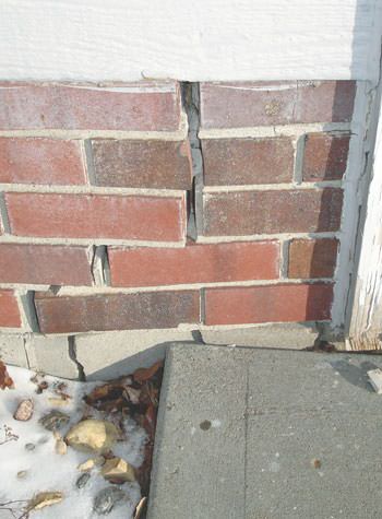 Severe street creep damage to a garage wall outside a Richland Center home