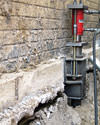 A completed installation of foundation push piers lifting a foundation in Caledonia