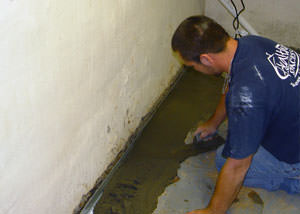 Restoring a concrete slab floor with fresh concrete after jackhammering it and installing a drain system in Greendale.