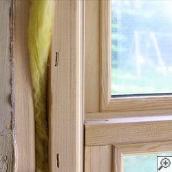 A wood framed basement window installed brand-new in Janesville.