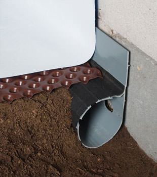 Closeup of a crawl space drainage system installed in Mindoro