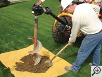 Auguring a hole in the earth for a foundation repair in Oak Creek