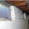 A foundation showing severe inward buckling along the windows in a Woodstock home.