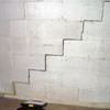 A diagonal stair step crack along the foundation wall of a Watertown home