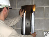Mounting a foundation wall plate for an earth anchor installation in Beloit.