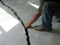a severely damaged cracked concrete slab floor in Fitchburg