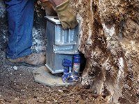 Securing a foundation footing bracket for a foundation repair system in Menomonee Falls.