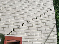 Stair-step cracks showing in a home foundation in Altoona