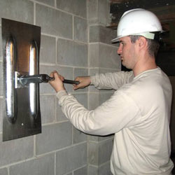 installing a wall anchor to repair an bowing foundation wall in La Crosse
