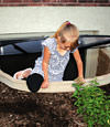 A child crawling out of an egress entryway window system in Eau Claire.